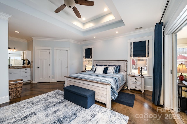 bedroom with multiple windows, visible vents, a tray ceiling, and recessed lighting