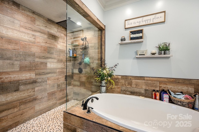 bathroom featuring a walk in shower, ornamental molding, and a bath