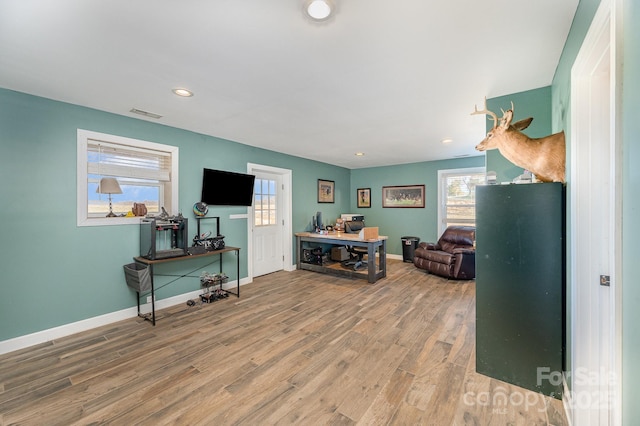 living room with recessed lighting, wood finished floors, visible vents, and baseboards