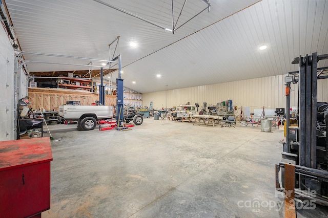 garage with a workshop area and metal wall