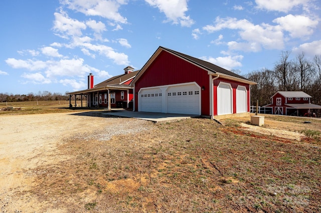 garage with dirt driveway