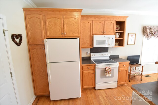 kitchen featuring white appliances, dark countertops, light wood-style flooring, and crown molding