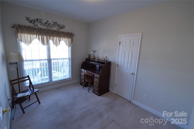 office with carpet flooring, visible vents, and baseboards