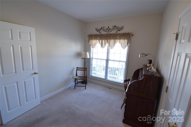 sitting room with baseboards, visible vents, and carpet flooring