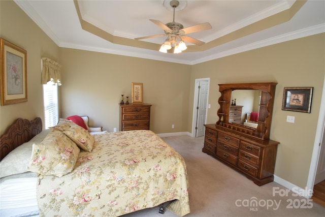 bedroom with light carpet, a tray ceiling, ornamental molding, and baseboards