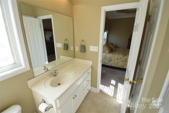 ensuite bathroom featuring crown molding, vanity, toilet, and ensuite bathroom