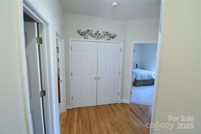 corridor with light wood-style flooring