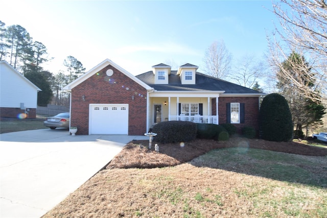 view of front of home featuring driveway, a garage, brick siding, a porch, and a front yard