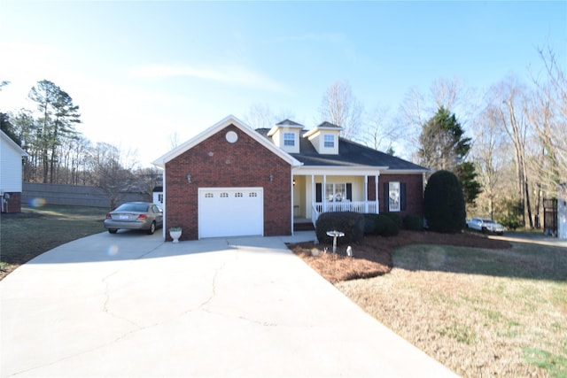 view of front of property with a porch, an attached garage, fence, driveway, and a front lawn