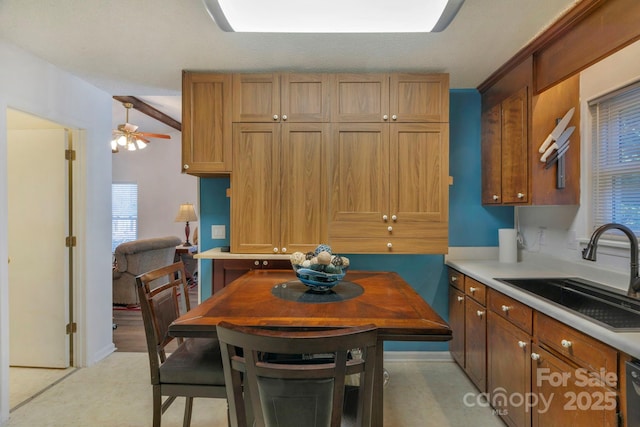 kitchen with brown cabinets, light countertops, and a sink