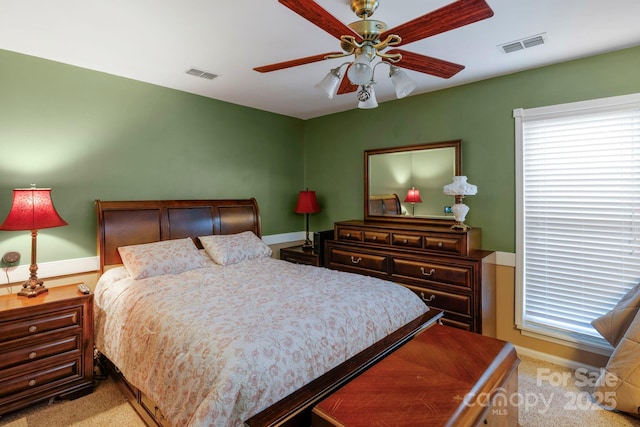 bedroom with light carpet, multiple windows, and visible vents