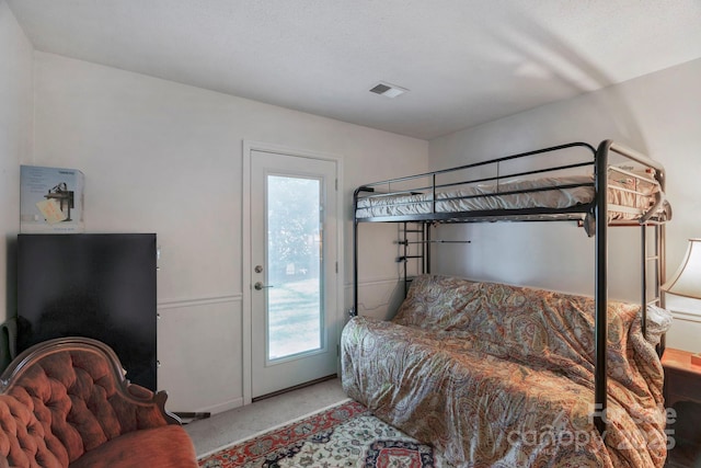 bedroom with visible vents and carpet flooring