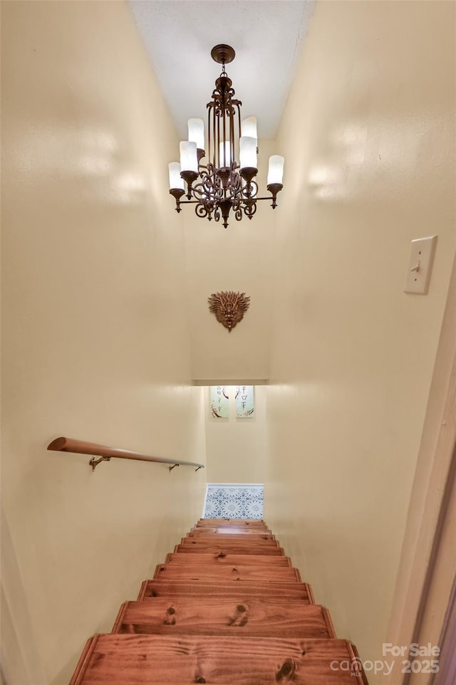 staircase featuring an inviting chandelier