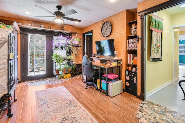 office area with wood finish floors, french doors, a paneled ceiling, ceiling fan, and baseboards