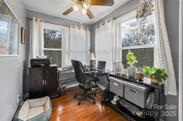 office space featuring ceiling fan, baseboards, and wood finished floors