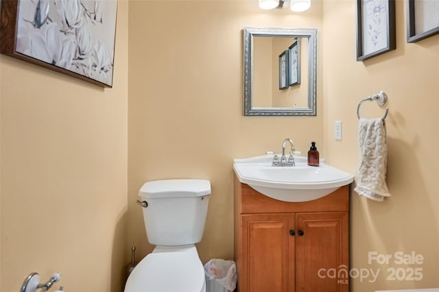 bathroom featuring toilet and vanity