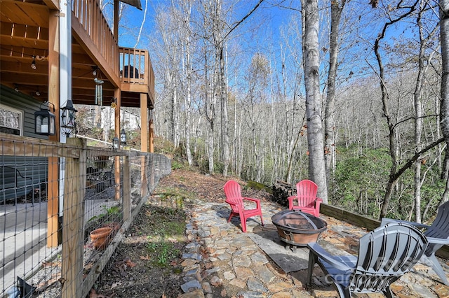 view of yard featuring an outdoor fire pit and a wooden deck