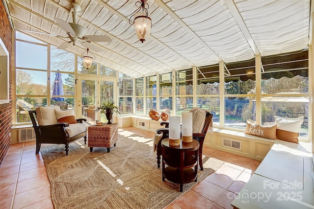 sunroom / solarium with visible vents, vaulted ceiling, and a ceiling fan