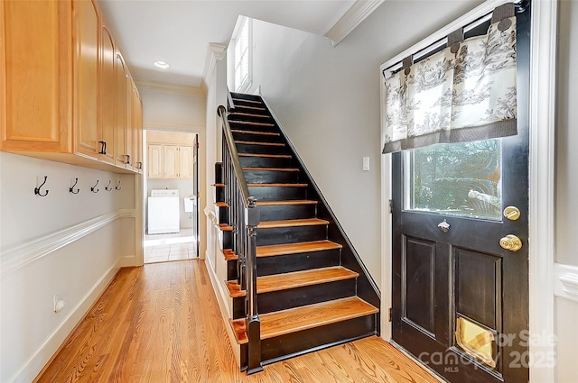 interior space with stairs, washer / clothes dryer, light wood-type flooring, and crown molding