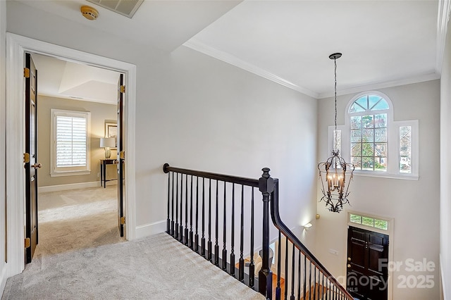 hallway with plenty of natural light, carpet, visible vents, and an upstairs landing