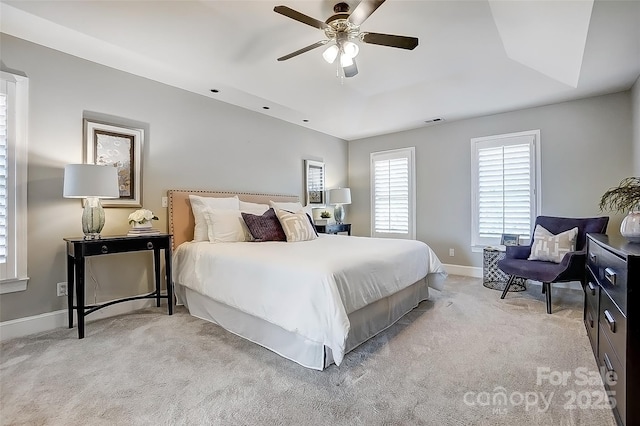 bedroom featuring light carpet, ceiling fan, visible vents, and baseboards