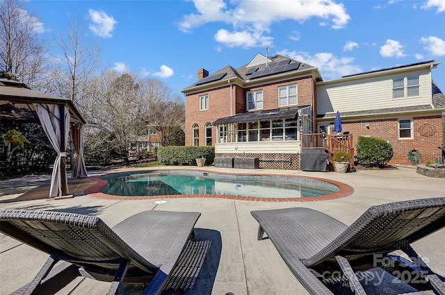 exterior space featuring a sunroom and a patio area