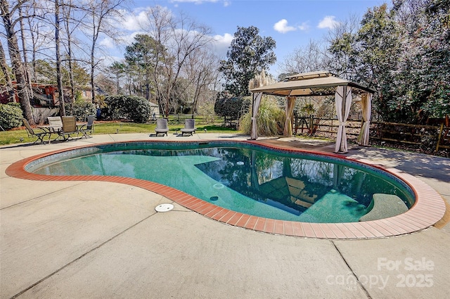 outdoor pool with fence, a patio, and a gazebo