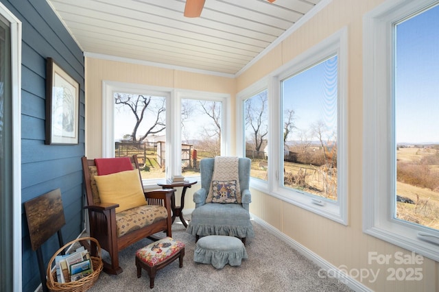 sunroom / solarium featuring a ceiling fan