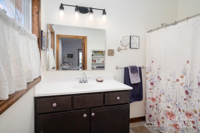 bathroom with tile patterned flooring, ensuite bathroom, and vanity