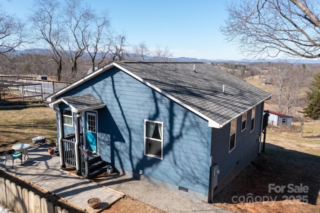 view of property exterior with a patio, a shingled roof, and crawl space