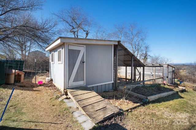 view of shed featuring a garden and fence