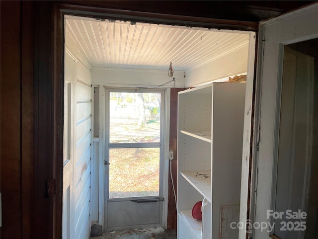 doorway to outside featuring wood ceiling and a wealth of natural light