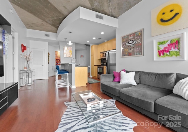 living room with visible vents and dark wood-style flooring