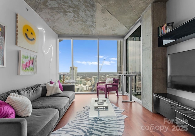 living area featuring a wall of windows and wood finished floors