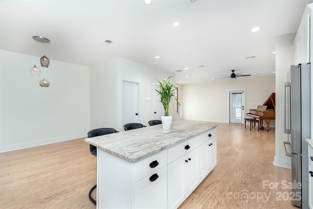 200 Stafford St, Black Mountain, NC 28711 - kitchen featuring recessed lighting, light wood-style flooring, freestanding refrigerator, a kitchen island, and light stone countertops
