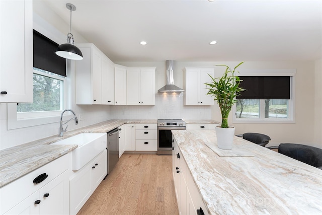 200 Stafford St, Black Mountain, NC 28711 - kitchen featuring a sink, light wood-style floors, appliances with stainless steel finishes, light stone countertops, and wall chimney exhaust hood
