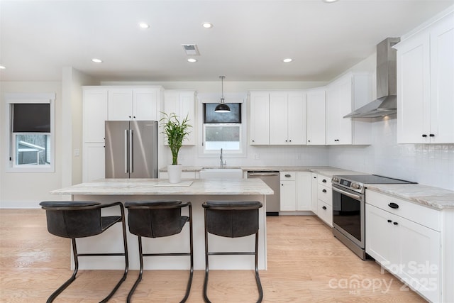 200 Stafford St, Black Mountain, NC 28711 - kitchen with wall chimney exhaust hood, a breakfast bar area, stainless steel appliances, and a sink