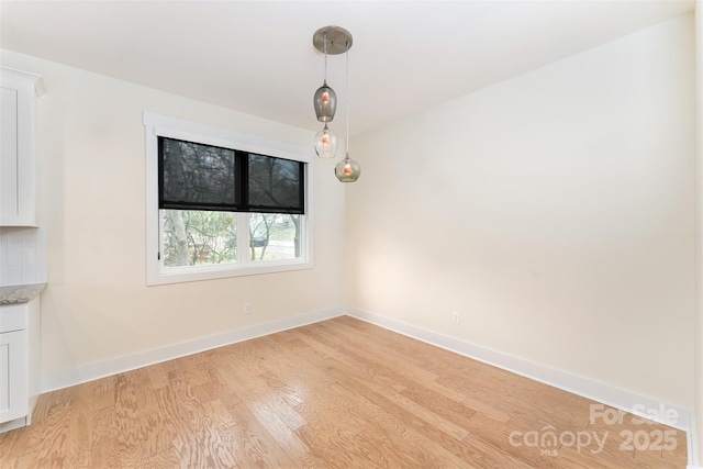 200 Stafford St, Black Mountain, NC 28711 - unfurnished dining area featuring light wood-style flooring and baseboards