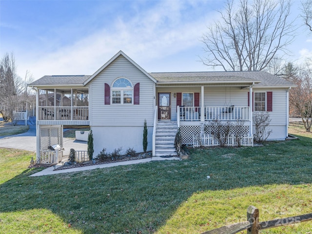 single story home featuring a sunroom, a front lawn, a carport, and concrete driveway