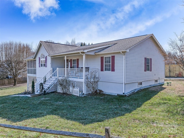 view of front of property featuring covered porch, a shingled roof, stairs, and a front yard