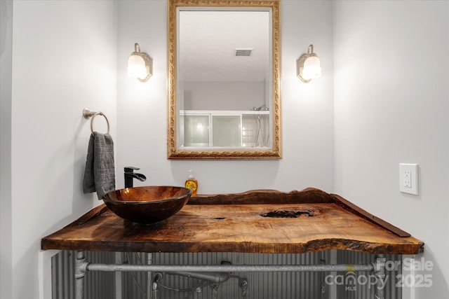 bathroom featuring visible vents and a sink