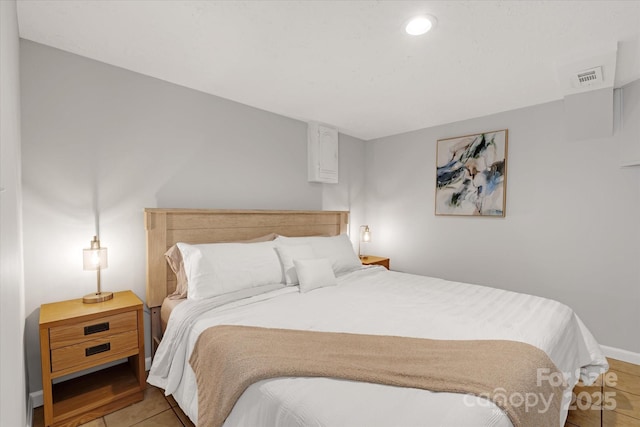 bedroom featuring light tile patterned floors and visible vents