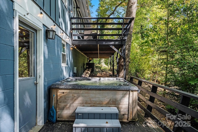 wooden deck featuring a hot tub