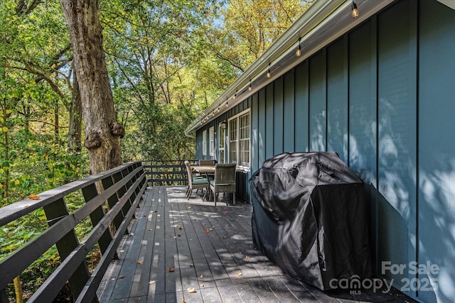 wooden terrace with outdoor dining space