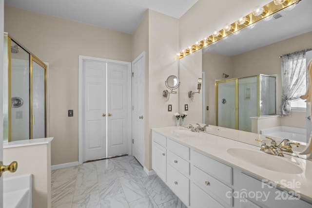 bathroom featuring double vanity, a stall shower, a sink, marble finish floor, and a bath