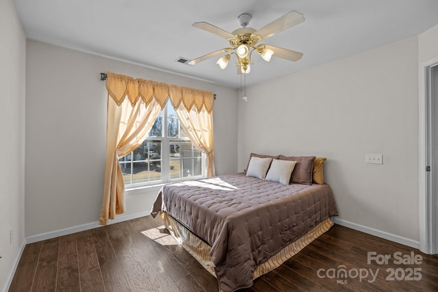 bedroom featuring ceiling fan, baseboards, and wood finished floors