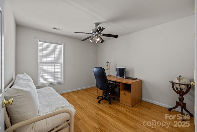 office space with baseboards, visible vents, and light wood-style floors