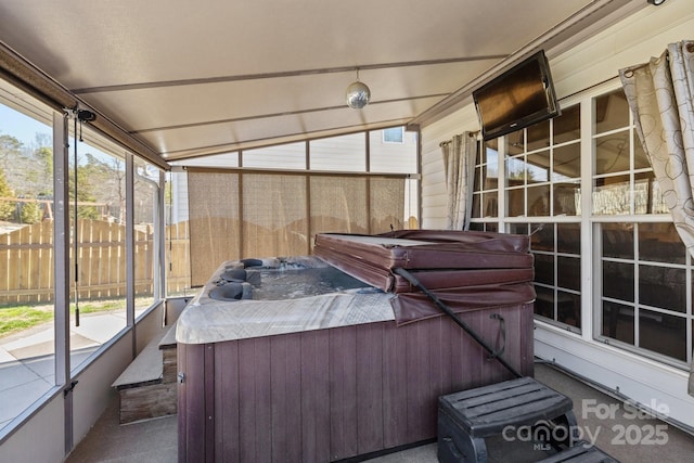 sunroom / solarium with vaulted ceiling and a hot tub