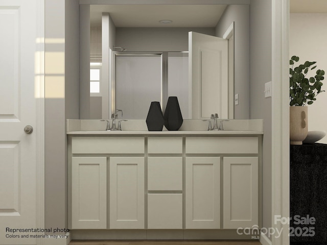 full bathroom with a shower with door, a sink, and double vanity