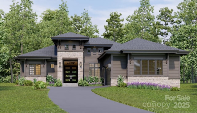 prairie-style house featuring stone siding, french doors, a shingled roof, and driveway